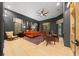 Main bedroom with a four-poster bed, seating area, and hardwood floors at 5004 Se 5Th Ave, Ocala, FL 34480