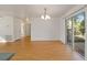 Light-filled dining area with wood flooring and access to other rooms at 5213 Se 114Th St, Belleview, FL 34420