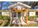 Inviting front porch with a green door and wooden beams at 5213 Se 114Th St, Belleview, FL 34420