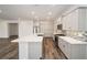 Modern kitchen with an island, white cabinets, and stylish backsplash at 6155 Sw 78Th Cir, Ocala, FL 34474