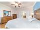 Bright and airy main bedroom with ensuite bathroom and wood floors at 7305 Sw 99Th Cir, Ocala, FL 34481