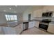 Modern kitchen with granite countertops and stainless steel appliances at 7613 Sw 103Rd Loop, Ocala, FL 34476