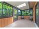 Relaxing screened porch with two chairs and skylight at 8101 Nw 46Th St, Ocala, FL 34482