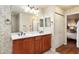 Double vanity bathroom with wood cabinets and mirror at 8718 Sw 83Rd Loop, Ocala, FL 34481