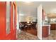 Bright entryway with red door opening to a view of the living room and kitchen at 8718 Sw 83Rd Loop, Ocala, FL 34481