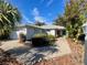 House exterior showcasing a brick walkway, attached garage, and neatly landscaped yard at 8718 Sw 83Rd Loop, Ocala, FL 34481