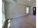 Spacious bedroom with carpeted floor and large window at 9679 Sw 46Th Ct, Ocala, FL 34476