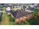Aerial view showcasing a single-story house, screened porch, and surrounding landscape at 9948 Sw 69Th Ln, Ocala, FL 34481