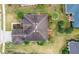 Top-down view of a house with a dark-colored roof and surrounding landscaping at 9948 Sw 69Th Ln, Ocala, FL 34481