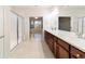 Double vanity bathroom with a walk-in shower and view into bedroom at 9948 Sw 69Th Ln, Ocala, FL 34481