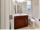 Clean bathroom with wood vanity, toilet and bathtub at 9948 Sw 69Th Ln, Ocala, FL 34481