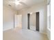 Bright bedroom with mirrored closet doors and ceiling fan at 9948 Sw 69Th Ln, Ocala, FL 34481
