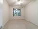 Bright bedroom with ceiling fan and window overlooking patio at 9948 Sw 69Th Ln, Ocala, FL 34481