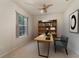 Bright home office featuring a built-in bookcase and desk at 9948 Sw 69Th Ln, Ocala, FL 34481