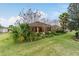 Single story home with screened lanai and lush landscaping at 9948 Sw 69Th Ln, Ocala, FL 34481