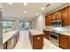 Open kitchen with island, stainless steel appliances, and ample cabinet space at 9948 Sw 69Th Ln, Ocala, FL 34481