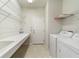 Laundry room with washer, dryer, and built-in shelving at 9948 Sw 69Th Ln, Ocala, FL 34481