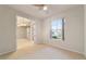 Bright home office features ceiling fan, carpet, and view into adjacent room at 9948 Sw 69Th Ln, Ocala, FL 34481