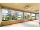 Spacious screened porch with ceiling fans and backyard view at 9948 Sw 69Th Ln, Ocala, FL 34481