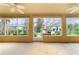 Large screened porch with ceiling fans and access to backyard at 9948 Sw 69Th Ln, Ocala, FL 34481