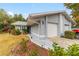 Gray exterior house with white garage door, landscaping, and walkway at 10463 Sw 85Th Ct, Ocala, FL 34481