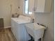 Laundry room with washer, dryer, and utility sink at 10865 Sw 78Th Ct, Ocala, FL 34476