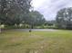 Outdoor basketball court with hoops and grassy surroundings at 131 Sw Sycamore Rd, Dunnellon, FL 34431