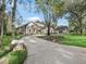 Long driveway leading to a two-story house with a detached garage at 1435 Se 73Rd Pl, Ocala, FL 34480