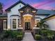 Elegant home entrance with stone accents and landscaping at 1435 Se 73Rd Pl, Ocala, FL 34480