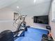 Home gym with elliptical, weights, and large screen TV at 1435 Se 73Rd Pl, Ocala, FL 34480