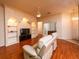 Living room with hardwood floors, a ceiling fan, and built-in shelving units at 2629 Sw 20Th Cir, Ocala, FL 34471