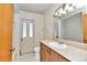 Bathroom with tiled walls, single vanity, and a door leading outside at 2970 Se 40Th St, Ocala, FL 34480