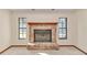 Brick fireplace flanked by windows in a carpeted living room at 2970 Se 40Th St, Ocala, FL 34480