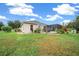 Home's backyard features a screened patio and well-manicured lawn at 3803 Se 6Th Ave, Ocala, FL 34480