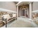 Front entry with stone accents and a rustic bench at 3803 Se 6Th Ave, Ocala, FL 34480