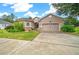 House exterior featuring a two-car garage and well-manicured lawn at 3803 Se 6Th Ave, Ocala, FL 34480