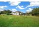 Single-story house exterior with a spacious lawn and partial view of the backyard at 3803 Se 6Th Ave, Ocala, FL 34480