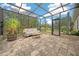 Spacious screened porch with seating area and brick-paver flooring at 3803 Se 6Th Ave, Ocala, FL 34480