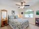 Spacious bedroom with ceiling fan, large window, and ample closet space at 5226 Nw 21St Loop, Ocala, FL 34482