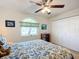 Bright bedroom with ceiling fan, window, and built-in shelving at 5226 Nw 21St Loop, Ocala, FL 34482