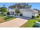 Single-story home with attached garage, landscaping, and a paved driveway at 5226 Nw 21St Loop, Ocala, FL 34482
