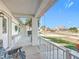 Front porch with white railing, chair, and view of the street at 5226 Nw 21St Loop, Ocala, FL 34482