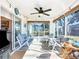 Bright sunroom with ceiling fan and comfortable seating at 5226 Nw 21St Loop, Ocala, FL 34482