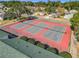 Three tennis courts with red surfaces and fencing at 5226 Nw 21St Loop, Ocala, FL 34482