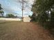 Small wooden shed in backyard, surrounded by trees and grass at 7289 Hemlock Rd, Ocala, FL 34472