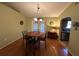 Bright dining room features hardwood floors, chandelier, and french doors at 7289 Hemlock Rd, Ocala, FL 34472