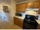 Kitchen area with wood cabinets, black appliances, and tile flooring at 7289 Hemlock Rd, Ocala, FL 34472