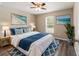 Bedroom with queen-size bed, blue accents, and large window at 7735 Sw 148Th St, Ocala, FL 34473