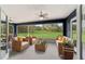 Relaxing screened porch overlooking a lush green backyard at 7735 Sw 148Th St, Ocala, FL 34473
