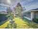 Private backyard with lush lawn, mature trees, and a screened patio area at 8327 Sw 79Th Cir, Ocala, FL 34476